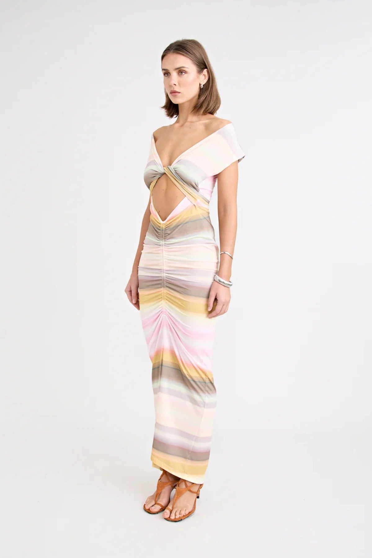 Elara Dress by Pfeiffer — a peach-toned stretch jersey midi with adjustable ties and front ruching for a custom, flattering silhouette.