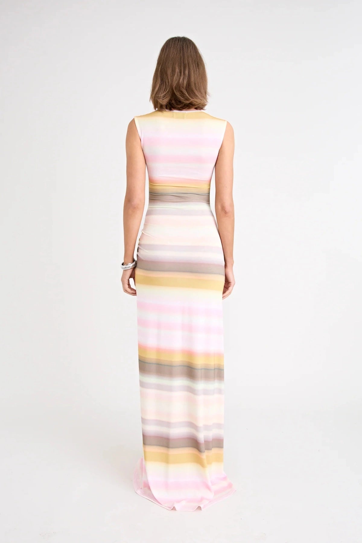 Elara Dress by Pfeiffer the Label, a printed stretch maxi with gathered sides and front split. Perfect for day-to-night styling.
