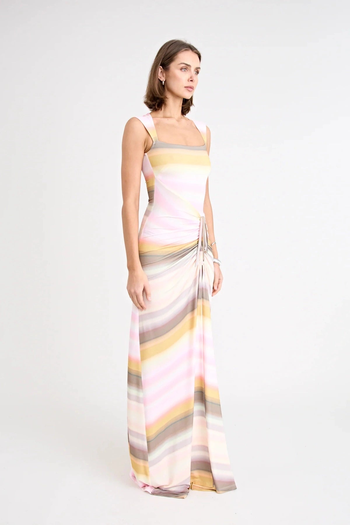 Elara Dress by Pfeiffer the Label, a printed stretch maxi with gathered sides and front split. Perfect for day-to-night styling.
