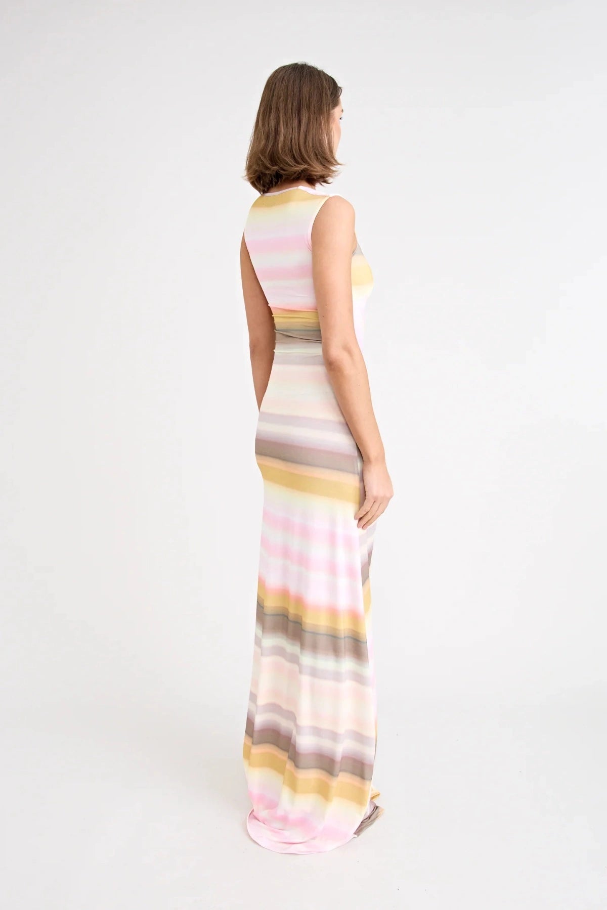Elara Dress by Pfeiffer the Label, a printed stretch maxi with gathered sides and front split. Perfect for day-to-night styling.
