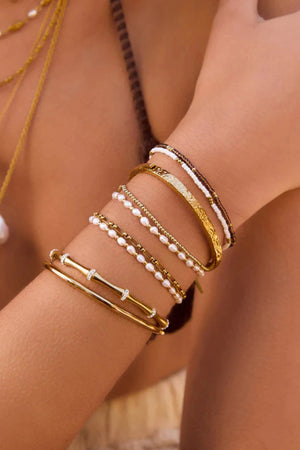 Electra Gold Cuff by Arms of Eve, sculptural gold cuff adorned with shimmering zircon stones for a bold, glamorous statement from day to night