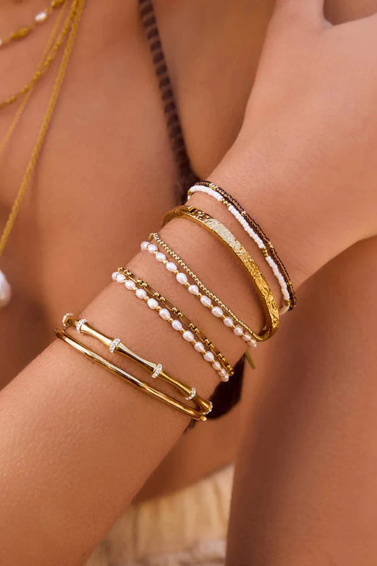 Electra Gold Cuff by Arms of Eve, sculptural gold cuff adorned with shimmering zircon stones for a bold, glamorous statement from day to night