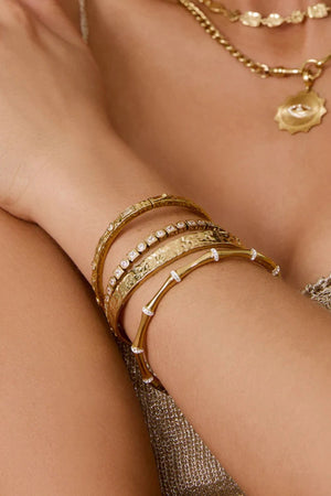 Electra Gold Cuff by Arms of Eve, sculptural gold cuff adorned with shimmering zircon stones for a bold, glamorous statement from day to night