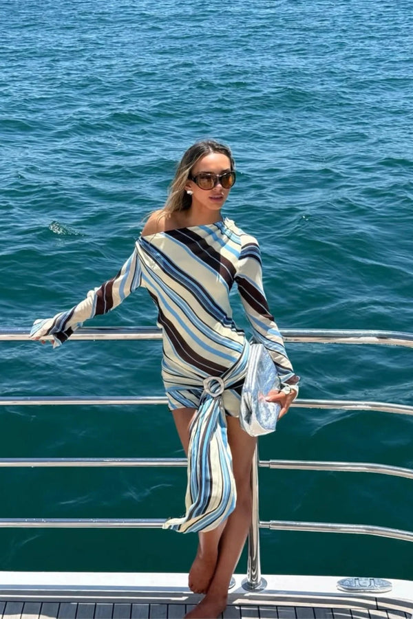 Elise Mini Dress by Benni, ocean stripe one-shoulder mini with flared sleeve, wrap sash waist and statement buckle detail.