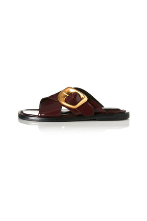 Elle Walnut Wax by Alias Mae, leather crossover sandal with gold buckle detail, a trendy piece perfect for summer dresses or relaxed looks.