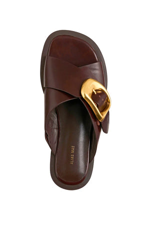 Elle Walnut Wax by Alias Mae, leather crossover sandal with gold buckle detail, a trendy piece perfect for summer dresses or relaxed looks.