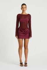 Elvira Mini Dress in Plum by Benni, a sheer stretch mesh mini with long sleeves, satin bralette panel, and draped cowl skirt.
