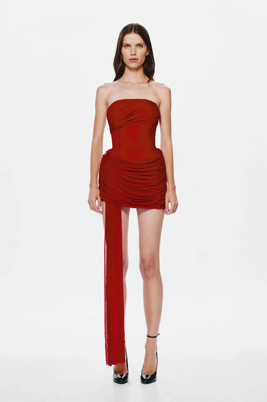 Ember Wrapped Mini Dress by MISHA — a strapless red mini with soft draping and a dramatic floor-length sash, perfect for evening events.