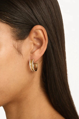 Entwined Hearts Large Hoops by By Charlotte — gold-plated intertwined crystal hoops symbolising connection and everyday elegance.