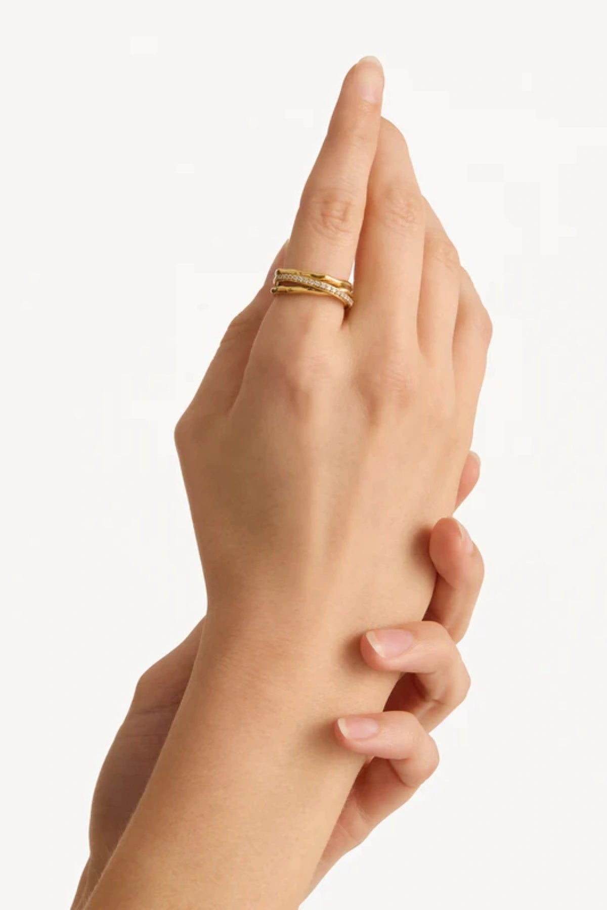 Entwined Hearts Ring by By Charlotte — a sterling silver double-band ring with CZ crystals, symbolising intertwined love and timeless elegance.