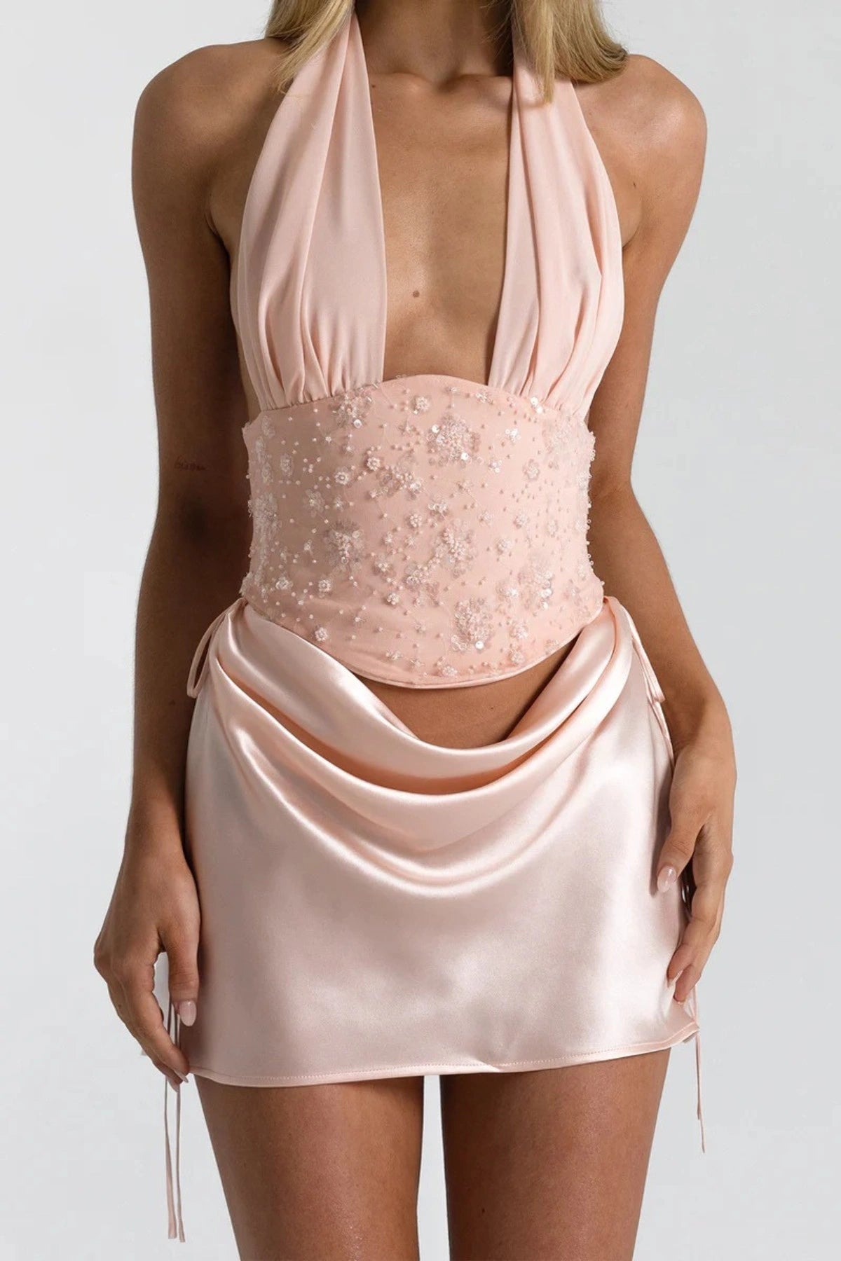 Evelyn Mini Skirt in Baby Pink by Natalie Rolt, a bias-cut silk mini with soft waist draping. Perfect for pairing with corset tops.