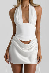Evelyn Mini Skirt in White by Natalie Rolt, a bias-cut silk mini with soft waist draping. Perfect for pairing with corset tops.
