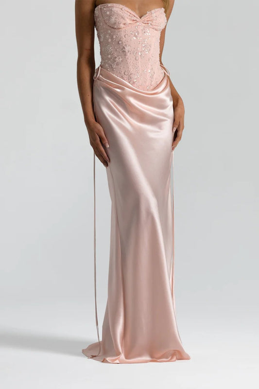Evelyn Skirt in Baby Pink by Natalie Rolt, a full-length silk design with draped waist and tie accents. Perfect for occasion dressing.