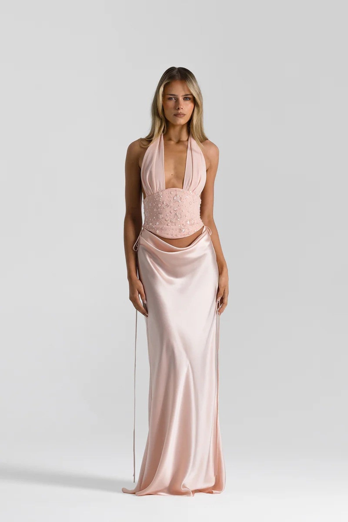 Evelyn Skirt in Baby Pink by Natalie Rolt, a full-length silk design with draped waist and tie accents. Perfect for occasion dressing.