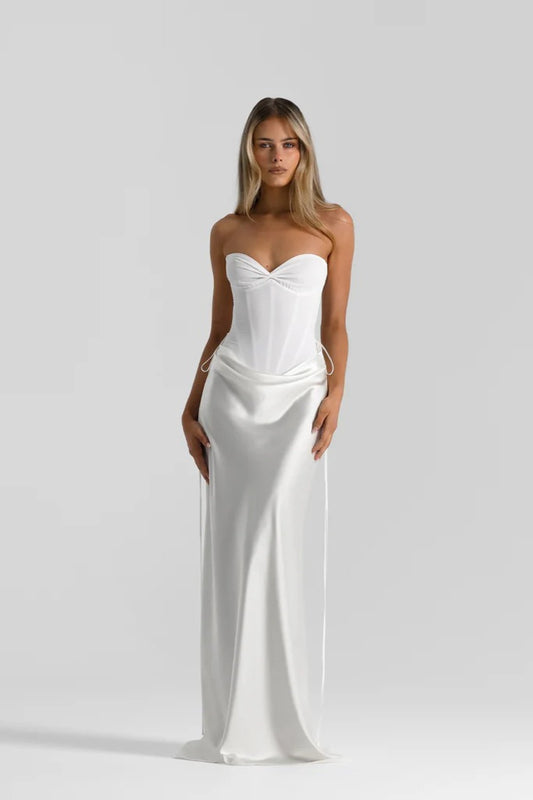 Evelyn Skirt in White by Natalie Rolt, a bias-cut silk maxi with waist draping and ties. Perfect for sleek events or bridal styling.