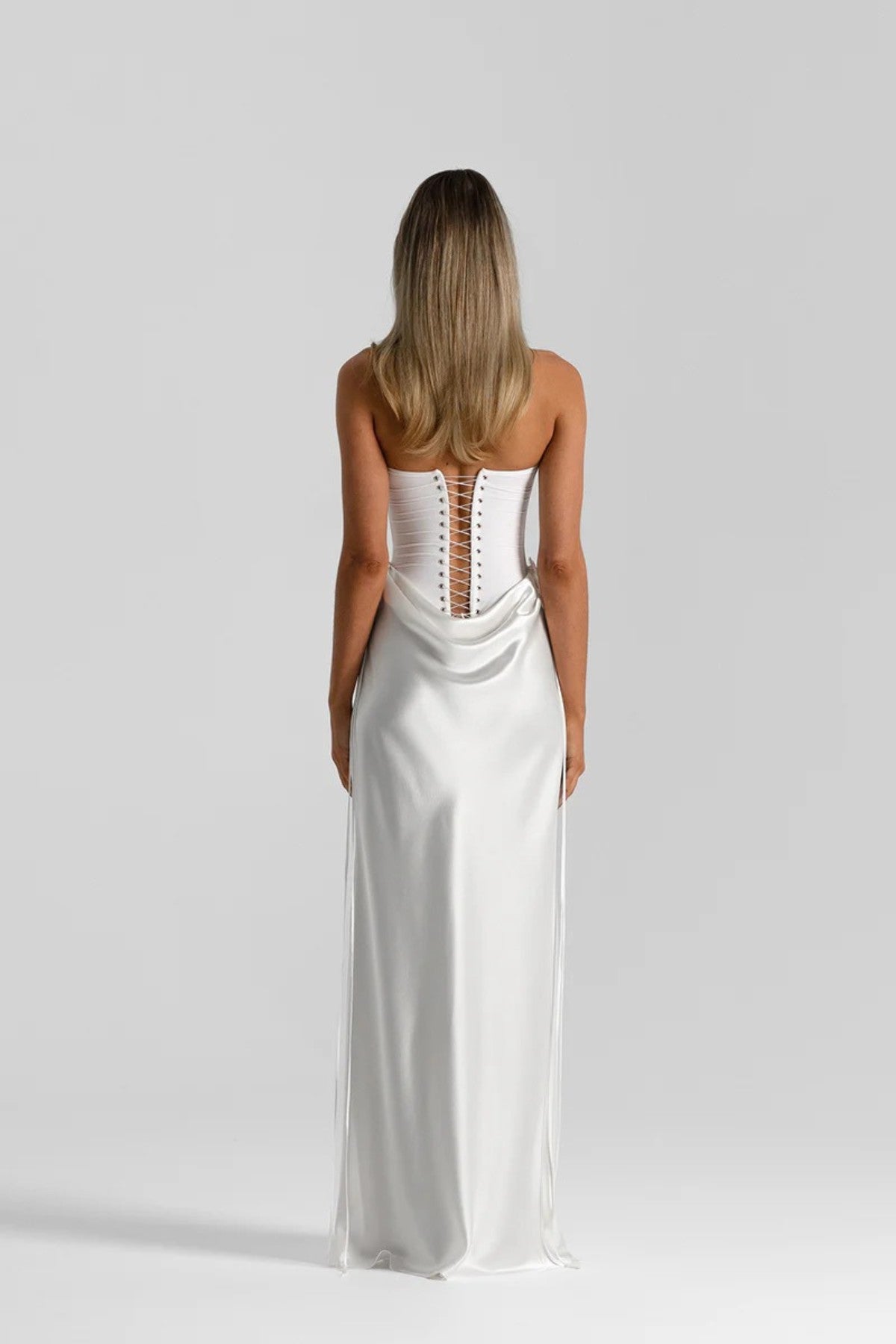 Evelyn Skirt in White by Natalie Rolt, a bias-cut silk maxi with waist draping and ties. Perfect for sleek events or bridal styling.