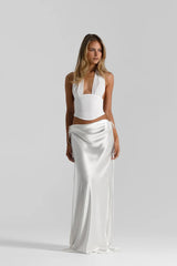 Evelyn Skirt in White by Natalie Rolt, a bias-cut silk maxi with waist draping and ties. Perfect for sleek events or bridal styling.