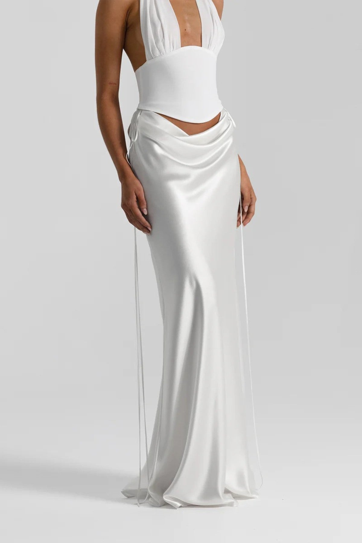 Evelyn Skirt in White by Natalie Rolt, a bias-cut silk maxi with waist draping and ties. Perfect for sleek events or bridal styling.