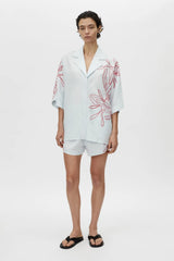 Eviva Shirt in Ice Blue by Camilla and Marc – a clshort-sleeve shirt with beaded embroidery and clean lines, perfect for bright polished days.