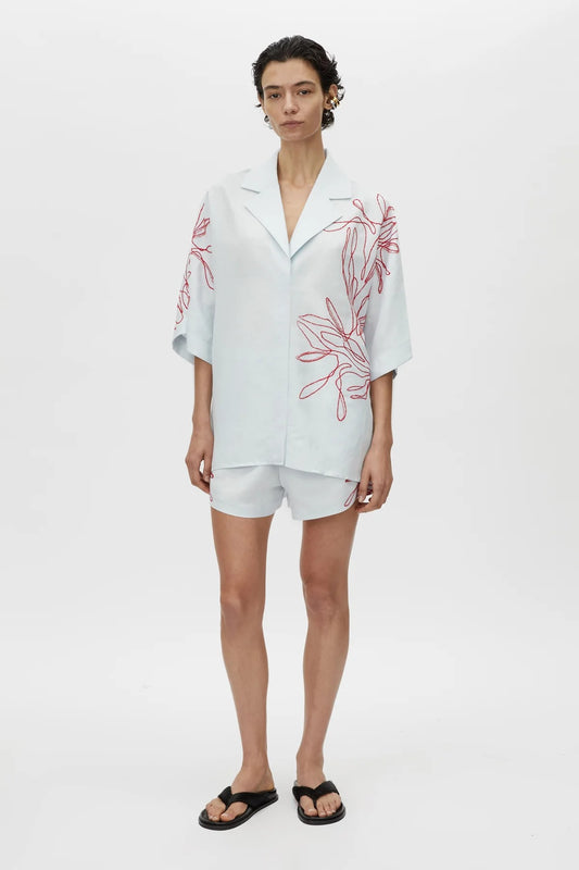 Eviva Shirt in Ice Blue by Camilla and Marc – a clshort-sleeve shirt with beaded embroidery and clean lines, perfect for bright polished days.