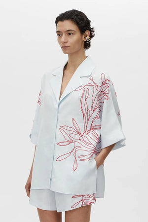 Eviva Shirt in Ice Blue by Camilla and Marc – a clshort-sleeve shirt with beaded embroidery and clean lines, perfect for bright polished days.