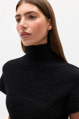 Evren Knit Top Black by Bayse – sculptural wool blend knit top with asymmetric wrap waist and high neckline.