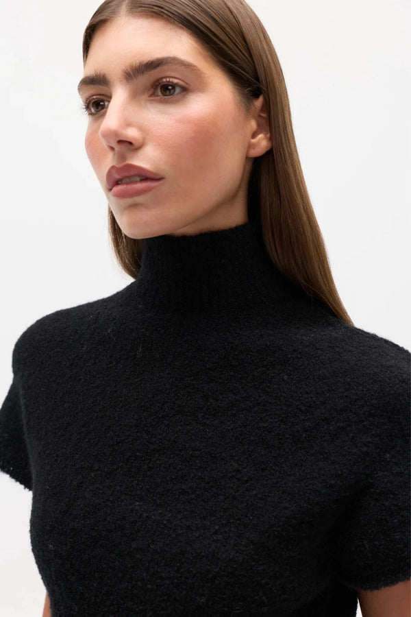 Evren Knit Top Black by Bayse – sculptural wool blend knit top with asymmetric wrap waist and high neckline.