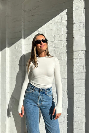 The Brooklyn Top White by Mossman, lightweight and super soft knitwear with thumb sleeve openings and a high round neckline, perfect for trendy layering days.