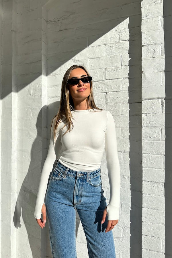 The Brooklyn Top White by Mossman, lightweight and super soft knitwear with thumb sleeve openings and a high round neckline, perfect for trendy layering days.