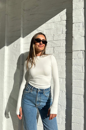 The Brooklyn Top White by Mossman, lightweight and super soft knitwear with thumb sleeve openings and a high round neckline, perfect for trendy layering days.
