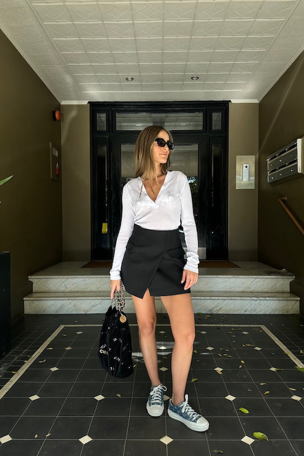 Sneaky Mini Skirt Black by Sneaky Link – A-line high-waisted mini with boned waist and flap pockets, perfect for day-to-night styling.