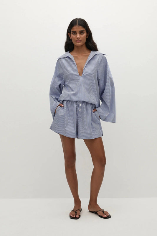 Faithfull the Brand Lonia Shorts in Helle Stripe Vintage Navy with relaxed boxer fit, mock fly, elastic waist and side pockets.
