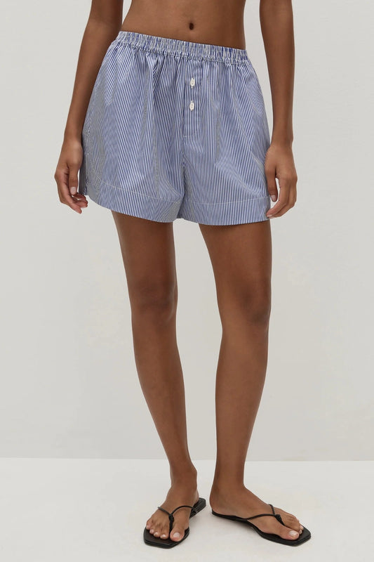 Faithfull the Brand Lonia Shorts in Helle Stripe Vintage Navy with relaxed boxer fit, mock fly, elastic waist and side pockets.
