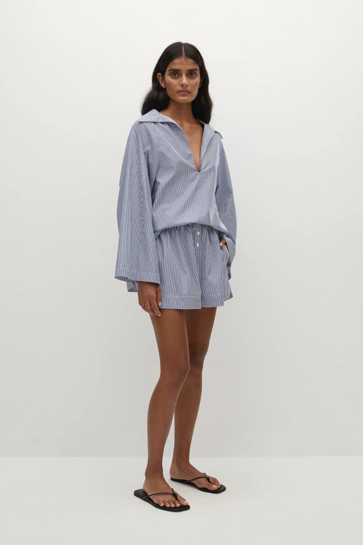 Faithfull the Brand Lonia Shorts in Helle Stripe Vintage Navy with relaxed boxer fit, mock fly, elastic waist and side pockets.
