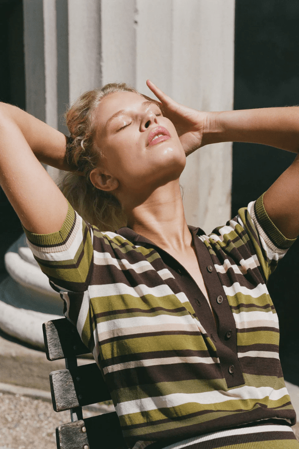 Sable Polo Shirt in Espresso Pine Stripe by Faithfull the Brand, classic polo with a deep V-neck and ribbed waistband, perfect for a chic, casual look when paired with coordinating skirts or denim.