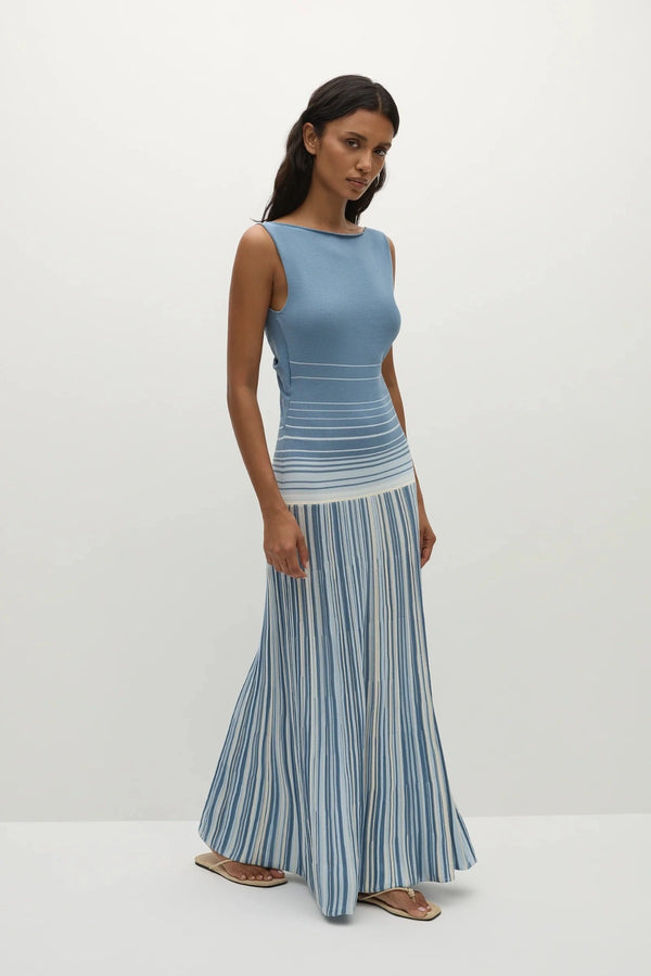 Faithfull the Brand Xyla Maxi Dress in Accordion Stripe Mineral Blue with boat neckline, twist knot back and flared A-line skirt.
