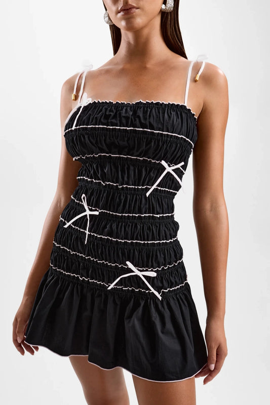 Femme Mini Dress Black by Cin Cin – cotton mini dress with shirred bodice, appliqué bows and contrast embroidery.