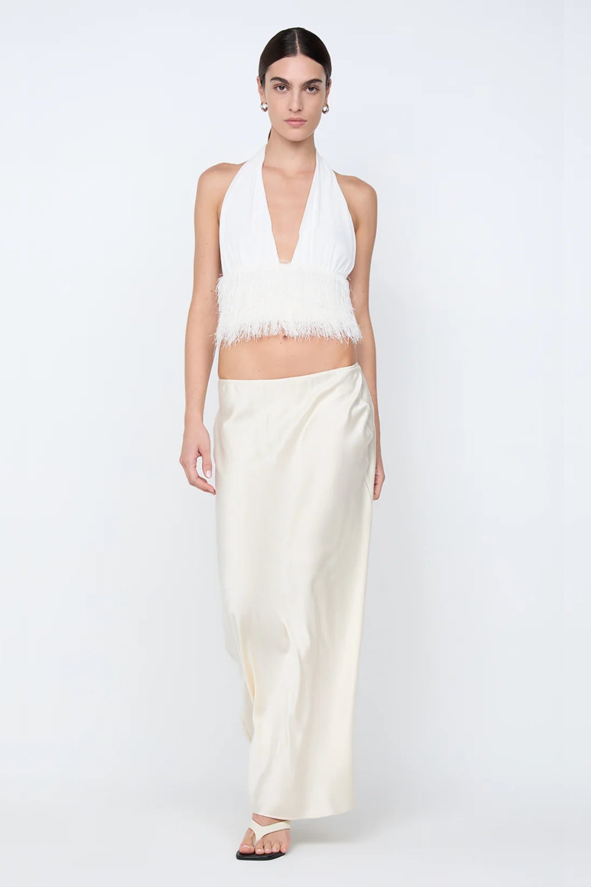 Finley Top by Bec + Bridge, a sleek halter silhouette with a statement fringe underbust detail—perfect for bridal celebrations or chic summer styling.