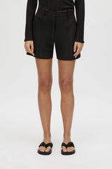 Floret Tailored Short by Camilla and Marc, a black wool-blend suiting short with resin buckle detail, belt loops and a tailored fit.