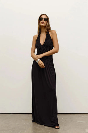 Frances Dress in Shadow by Bayse, a full-length ruched dress with a plunging halter neckline and open back for elevated evenings.