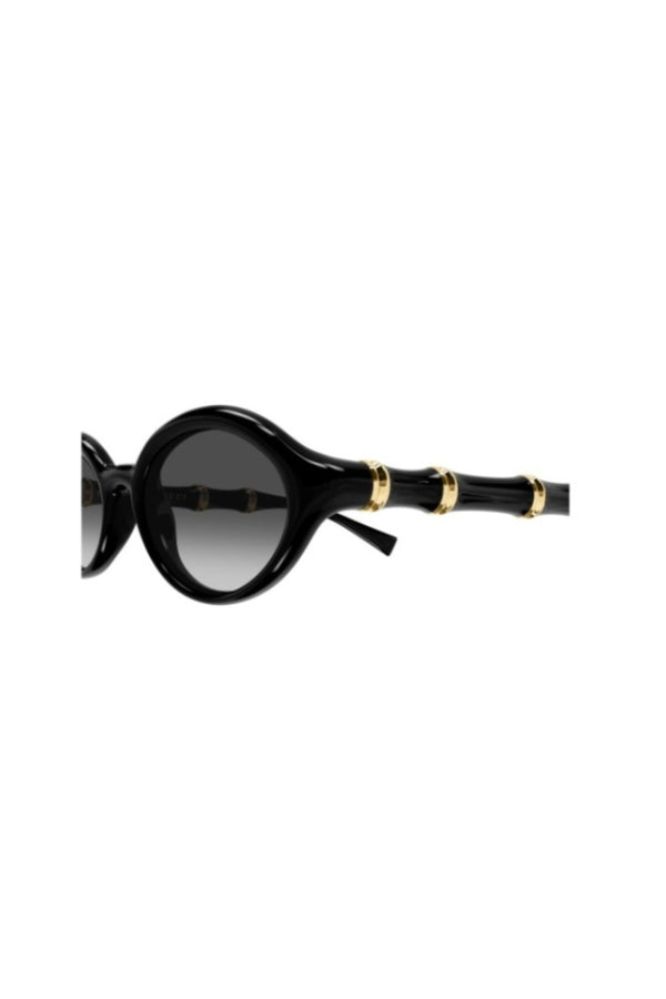 GG2059S001 Black by Gucci – oval sunglasses with bamboo detail and slim frame. Perfect for elevated styling.