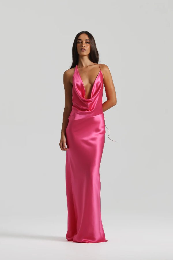 Gabi Gown Neon Pink by Natalie Rolt – A vibrant, bias-cut silk gown with dramatic open back and adjustable ties, perfect for making a trendy statement at special events.