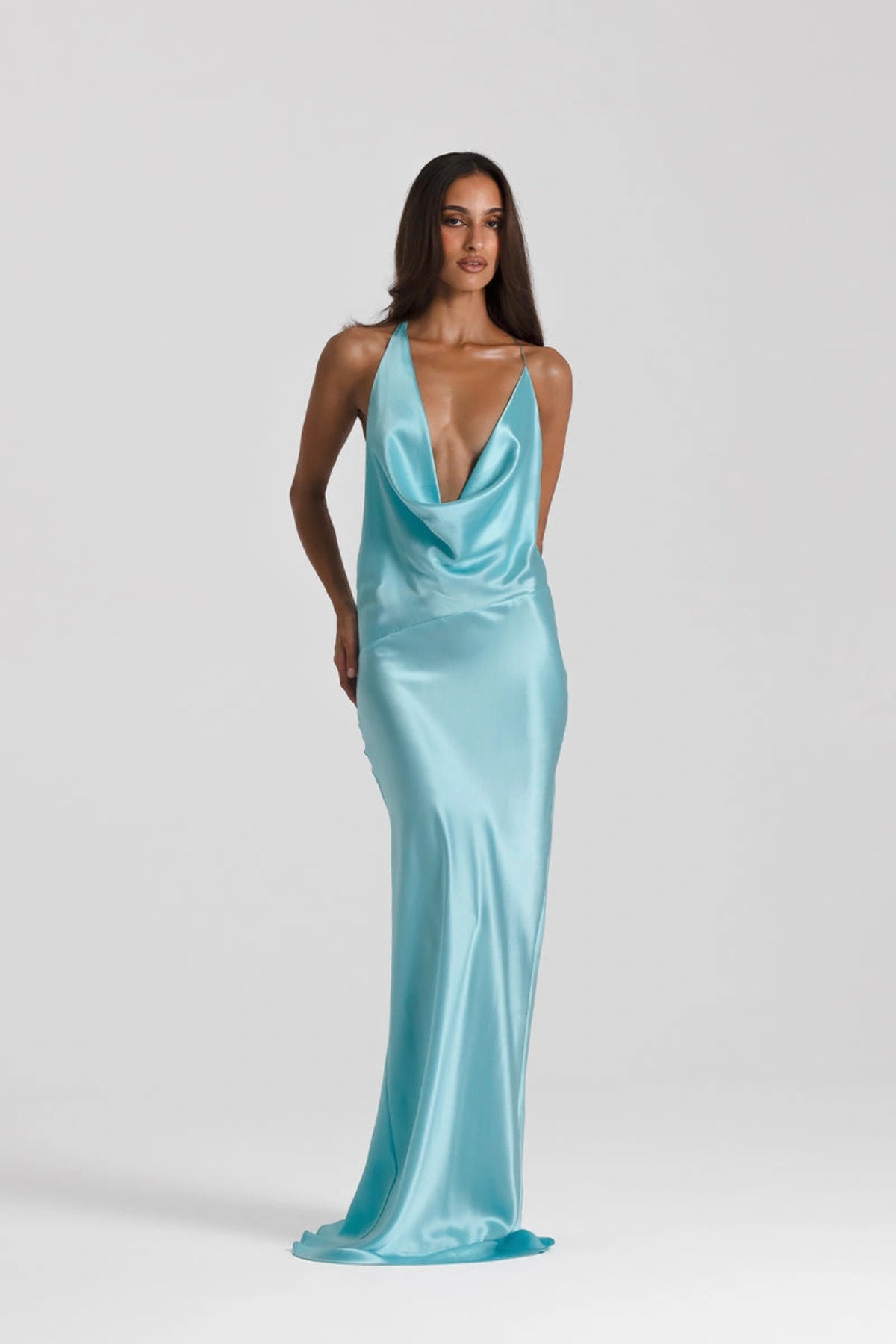 Gabi Gown in Turquoise by Natalie Rolt, handcrafted in Australia from 100% silk featuring an open back, draped neckline, and asymmetric silhouette.