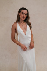 Gia V Neck Maxi Dress White by Sneaky Link – a flowy maxi with deep neckline and single strap. Perfect for elegant styling.