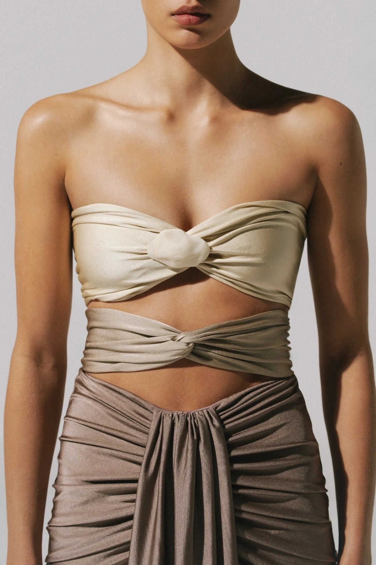 Giselle Maxi Dress by Baobab, a strapless gown with knot drape and front slit. Finished with a cascading hem and sculptural shape.