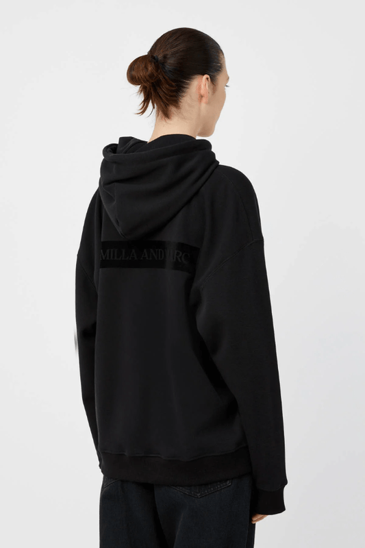 Grid Flocking Logo Hoodie Black by Camilla and Marc – Oversized fit with lined hood, flat drawcord, ribbed cuffs and hem, twin needle stitching, and subtle toothbrush flocked logo.