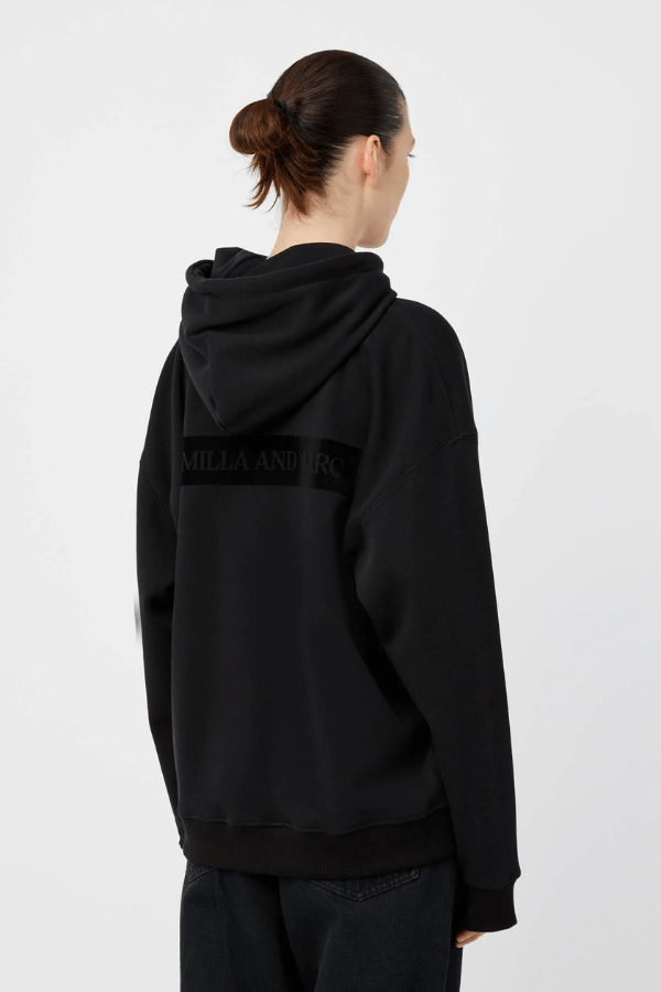 Grid Flocking Logo Hoodie Black by Camilla and Marc – Oversized fit with lined hood, flat drawcord, ribbed cuffs and hem, twin needle stitching, and subtle toothbrush flocked logo.