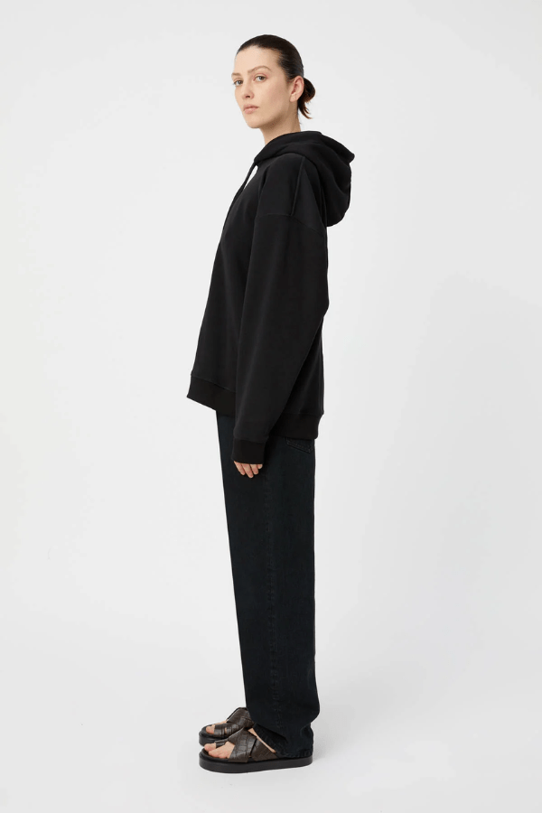 Grid Flocking Logo Hoodie Black by Camilla and Marc – Oversized fit with lined hood, flat drawcord, ribbed cuffs and hem, twin needle stitching, and subtle toothbrush flocked logo.