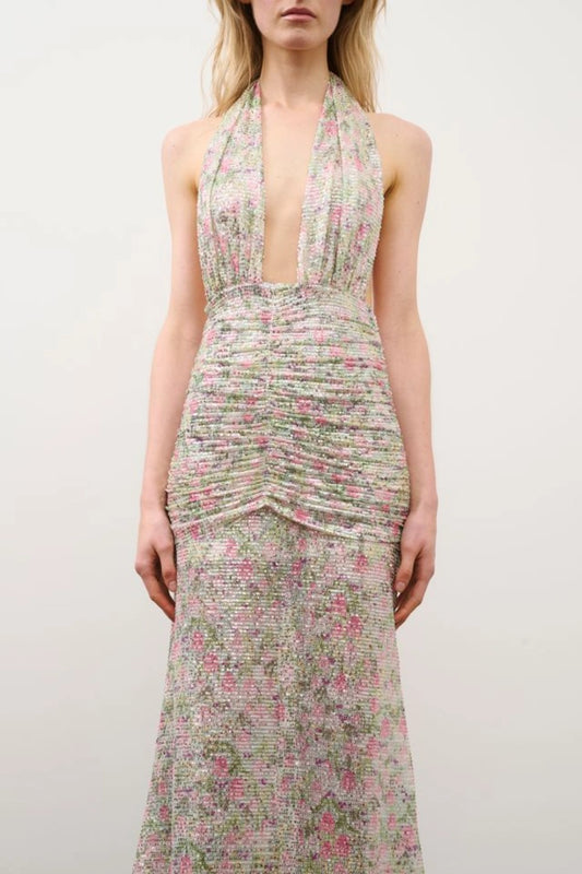 Hailey Dress in Floral Silver Sequin by DŽO, a full-length sequin gown with halter neckline, ruched waist, and floral overlay.