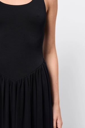 Haven Midi Dress Black by Mossman, a sleeveless sculpted midi with dipped waist and bubble hem. Perfect for day to night wear.